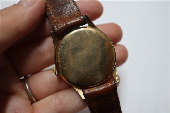A gentlemans 1950s 9ct gold Omega manual wind wrist watch, on leather strap with Omega buckle, movement c.266.